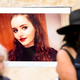 Members of the public walk past a photo of Grace Millane during a vigil at Civic Square on December 12, 2018 in Wellington, New Zealand.
